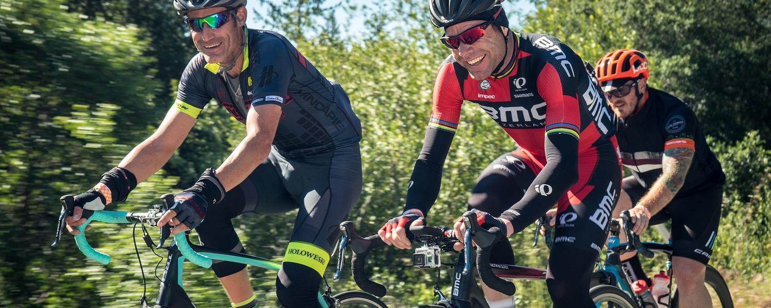three male cyclists riding their bikes together