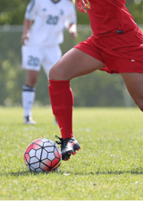 soccer player kicking soccer ball