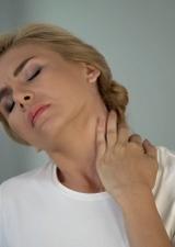 Woman rubbing her sore neck